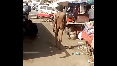 indian man roaming nude in market
